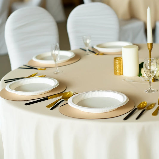 Image of an elegant ivory-themed table setting featuring disposable ivory plastic plates and table covers for a formal event. 