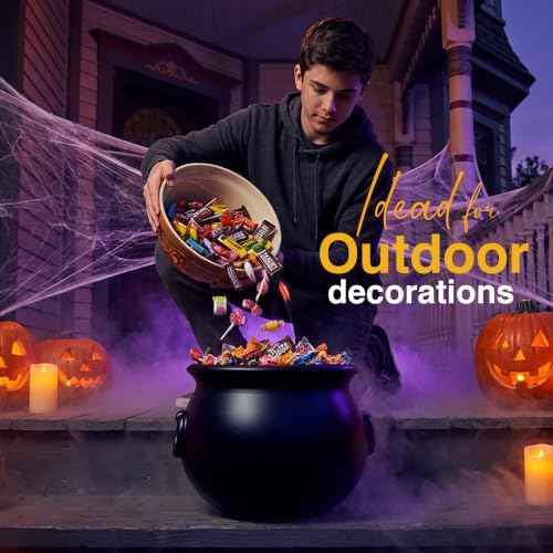 Pouring candy into a black cauldron for outdoor Halloween porch decorations